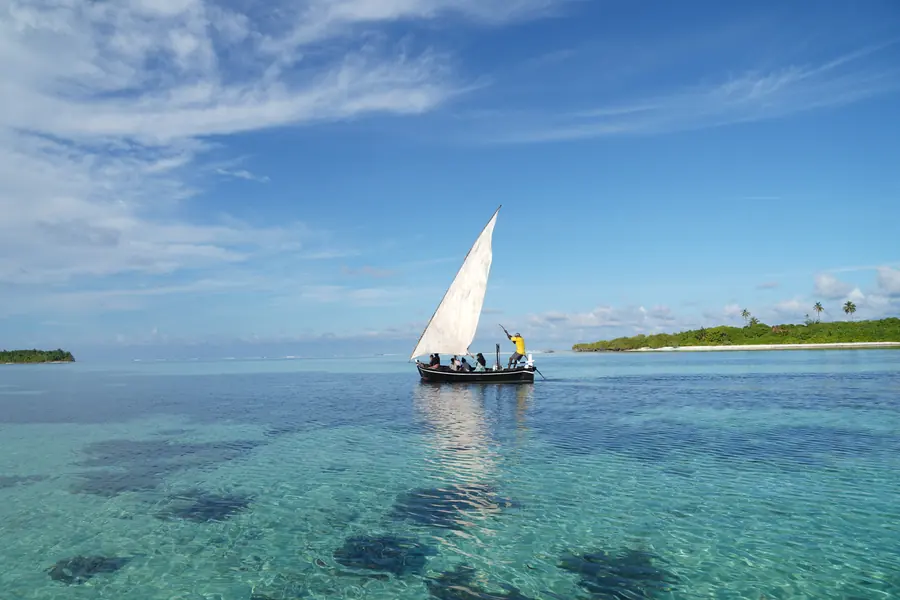 A dhoni sailing between islands, Huvadhu Atoll